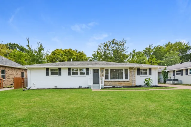 a front view of house with yard and green space