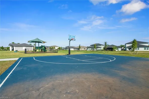 a view of a green field with sitting area