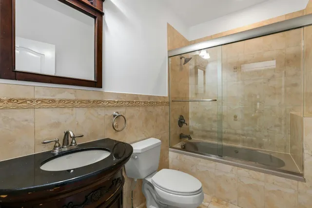 a bathroom with a sink toilet a mirror and shower