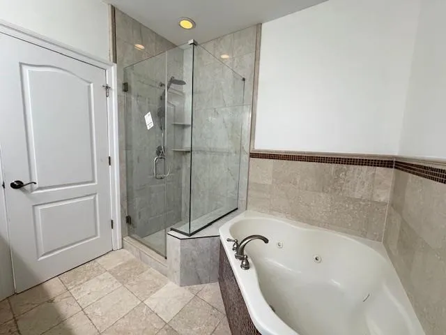 a bathroom with a bathtub and a shower