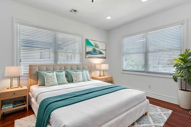 a bedroom with a bed and a window