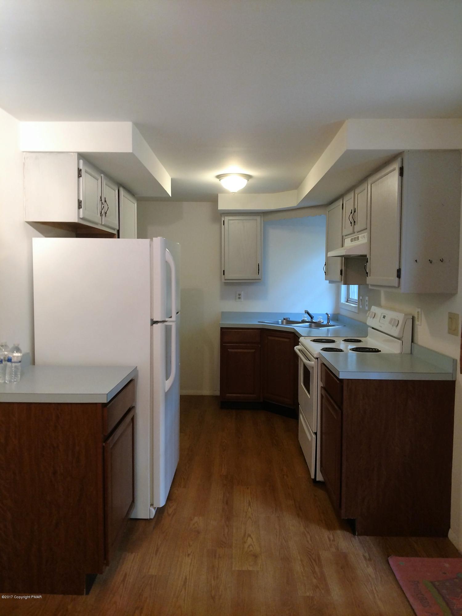 1416 Silver Maple Road Effort, PA 18330 - Photo 6 of 21 a kitchen with stainless steel appliances a refrigerator a sink and white cabinets