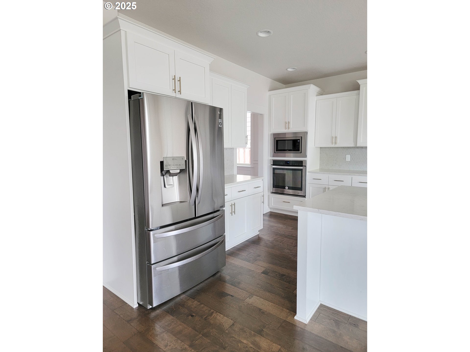 1222 Brookside Avenue Forest Grove, OR 97116 - Photo 11 of 30 a kitchen with kitchen island a refrigerator and cabinets