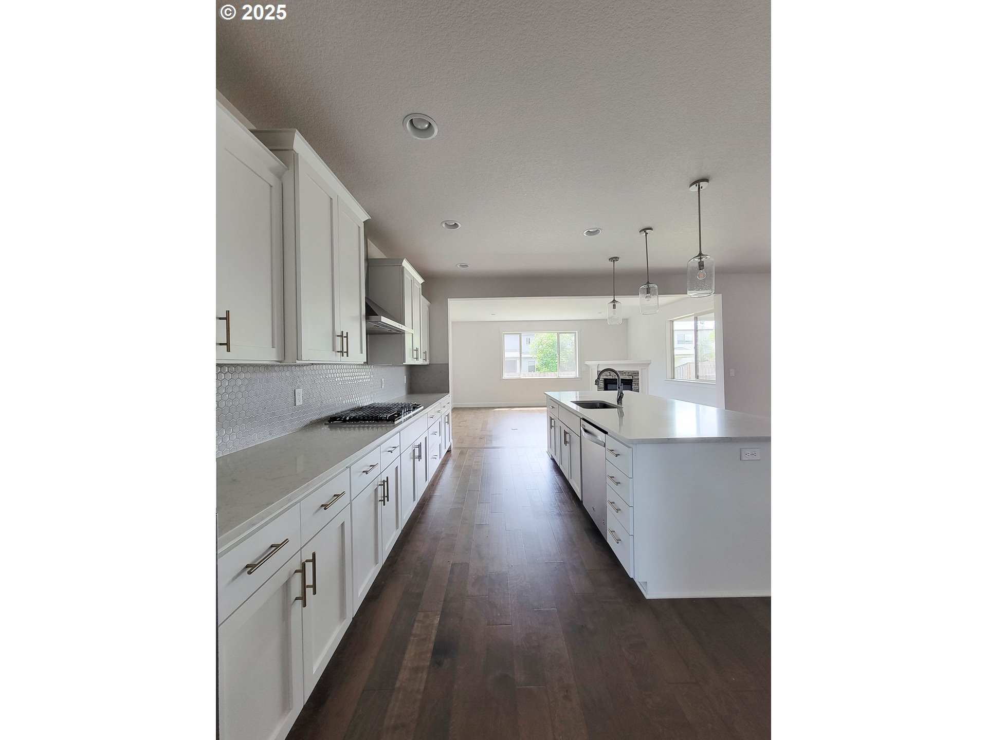 1222 Brookside Avenue Forest Grove, OR 97116 - Photo 8 of 30 a large kitchen with kitchen island white cabinets and stainless steel appliances