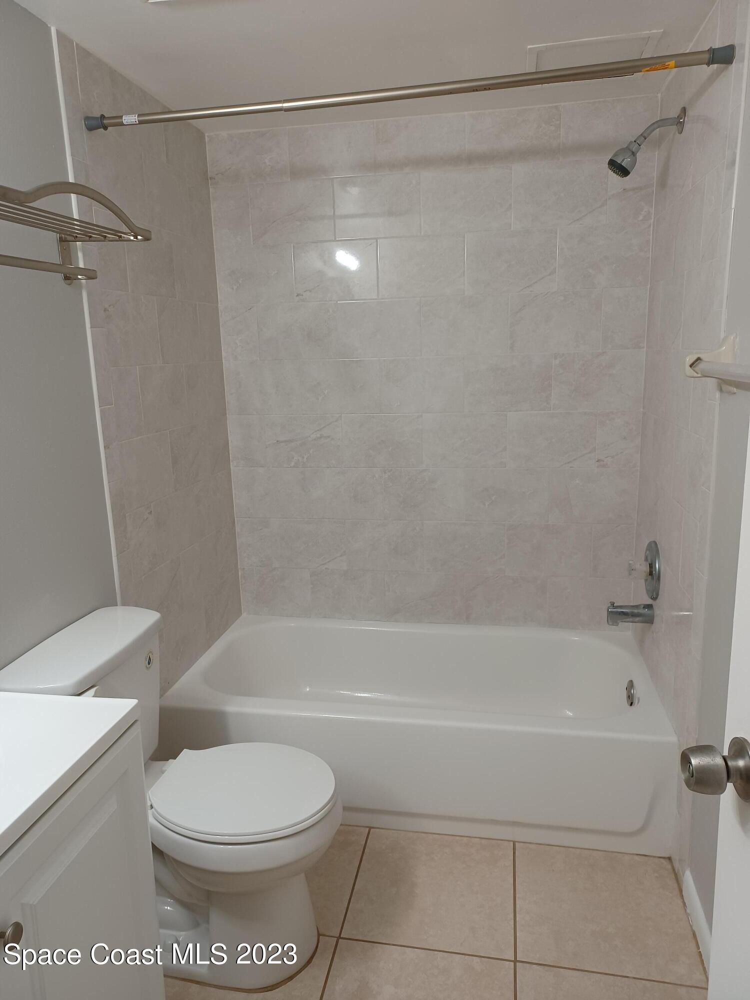 1698 Sunny Brook Lane, Unit G110 Palm Bay, FL 32905 - Photo 11 of 18 a bathroom with a toilet and a shower