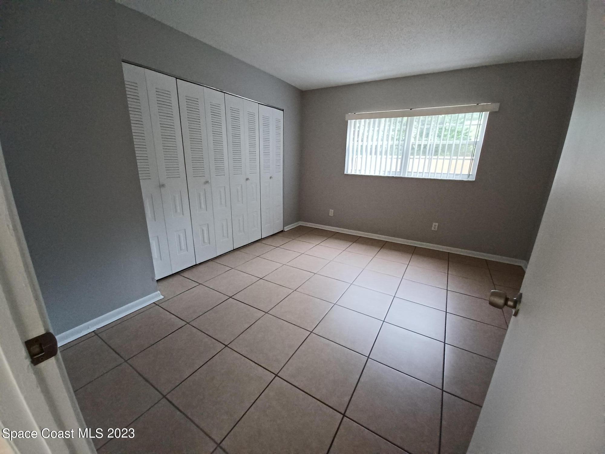 1698 Sunny Brook Lane, Unit G110 Palm Bay, FL 32905 - Photo 13 of 18 a view of an empty room and window
