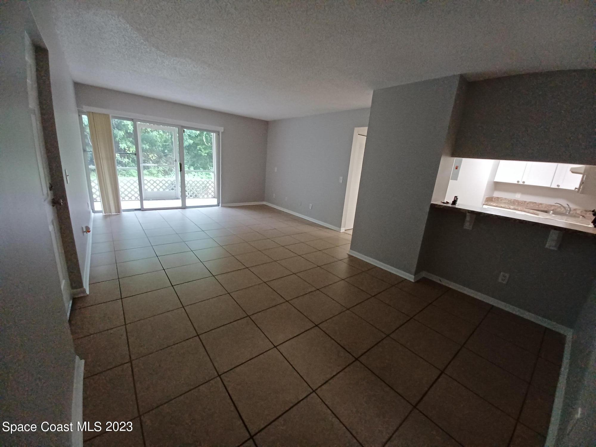 1698 Sunny Brook Lane, Unit G110 Palm Bay, FL 32905 - Photo 2 of 18 a view of an empty room with a window