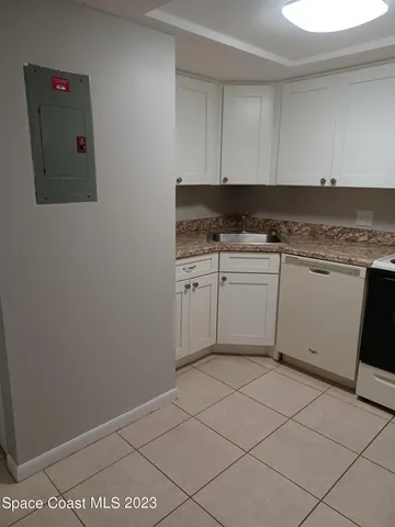a kitchen with a sink cabinets and utility room