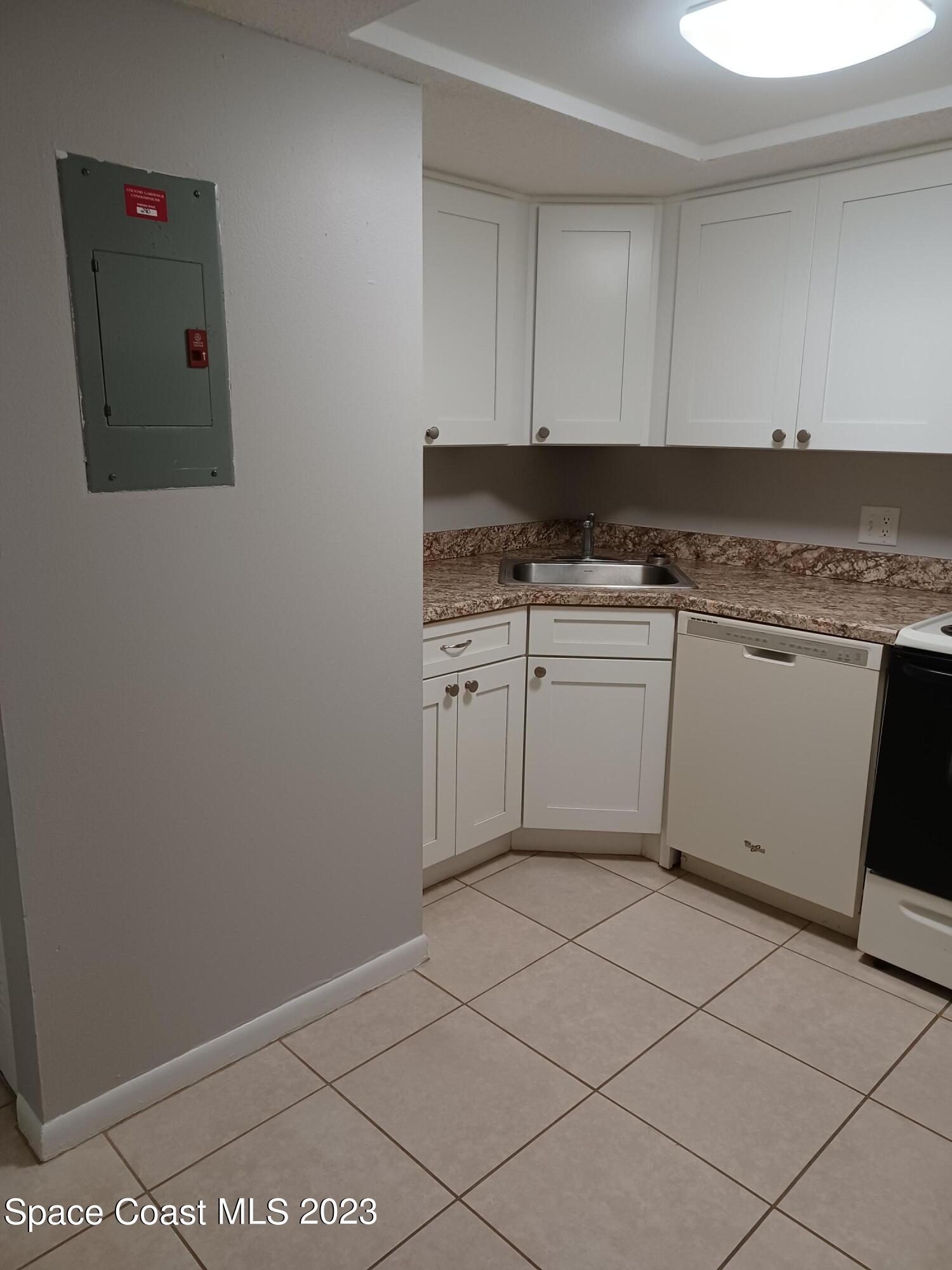 1698 Sunny Brook Lane, Unit G110 Palm Bay, FL 32905 - Photo 6 of 18 a kitchen with a sink cabinets and utility room