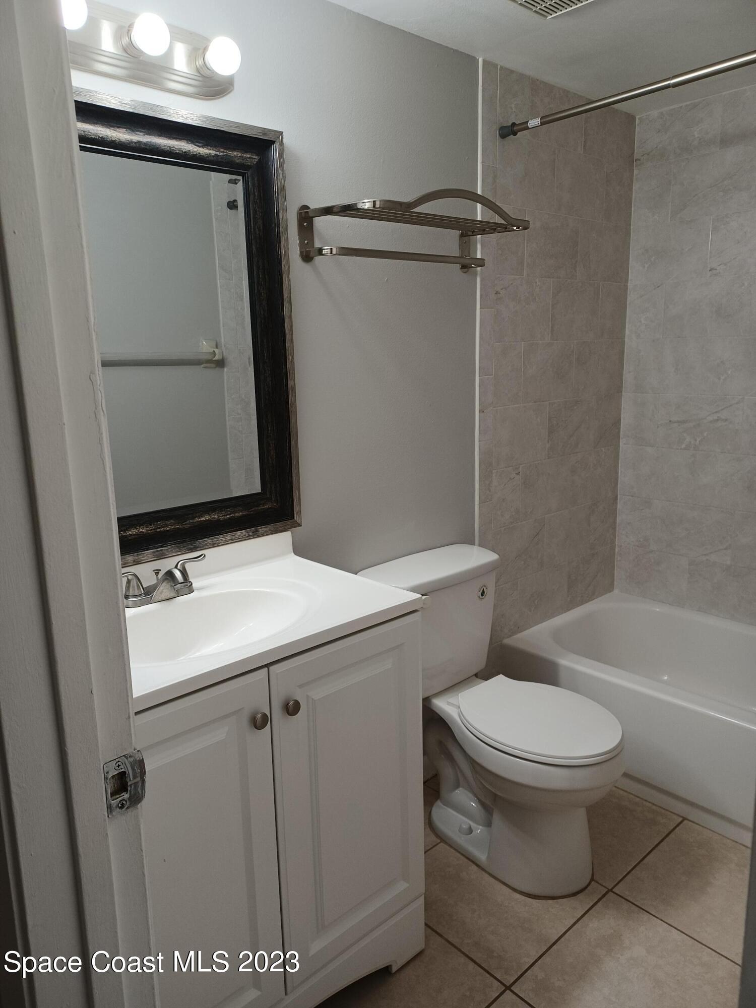 1698 Sunny Brook Lane, Unit G110 Palm Bay, FL 32905 - Photo 10 of 18 a bathroom with a sink a toilet and shower