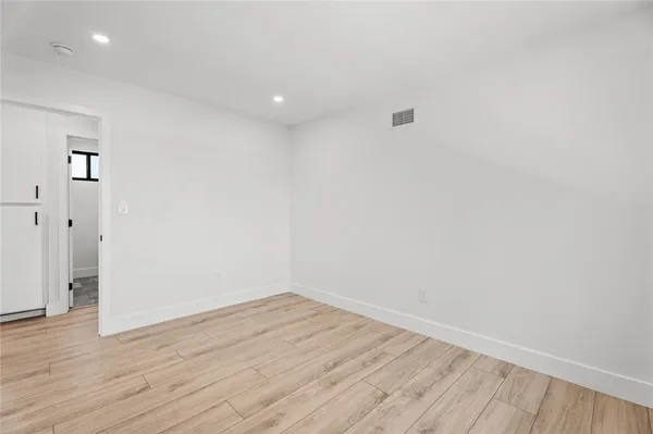 a view of room with wooden floor and window