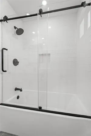 a bathroom with a shower and a shower
