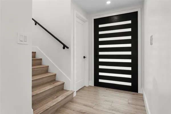 a view of a room with stairs and wooden floor