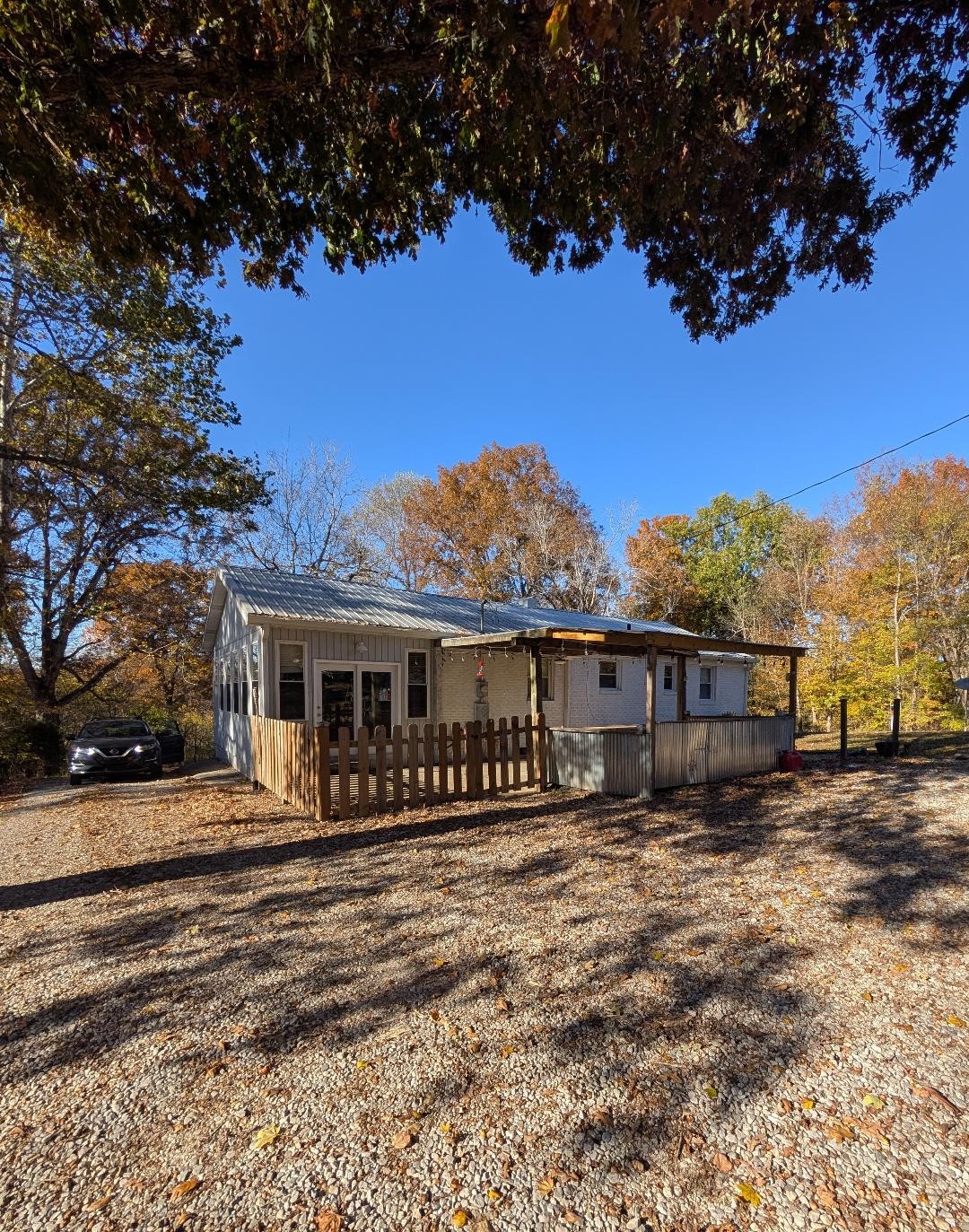 11774 Hopkinsville Road Princeton, KY 42445 - Photo 19 of 25 a view of a house with a wooden deck and a big yard