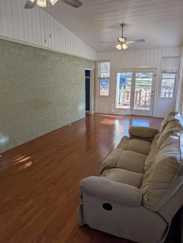 a living room with furniture and a chandelier