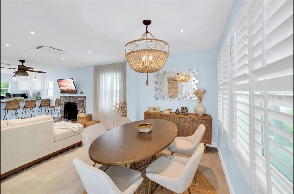 1210 Bay Palm Boulevard Indian Rocks Beach, FL 33785 - Photo 11 of 19 a living room with fireplace furniture and a chandelier