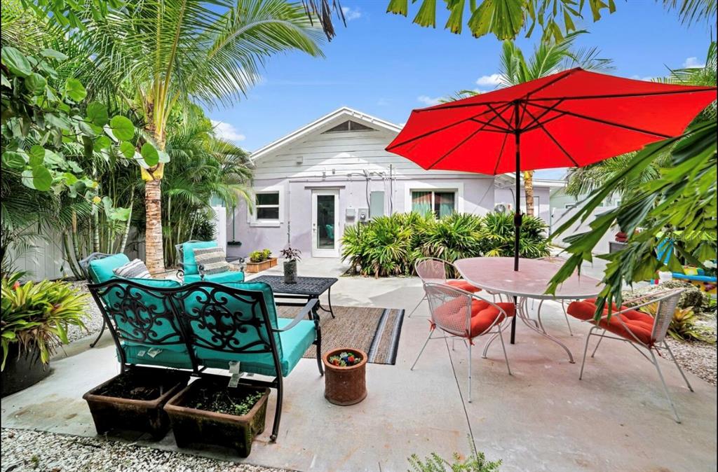 1210 Bay Palm Boulevard Indian Rocks Beach, FL 33785 - Photo 19 of 19 a view of patio with chairs and table under an umbrella