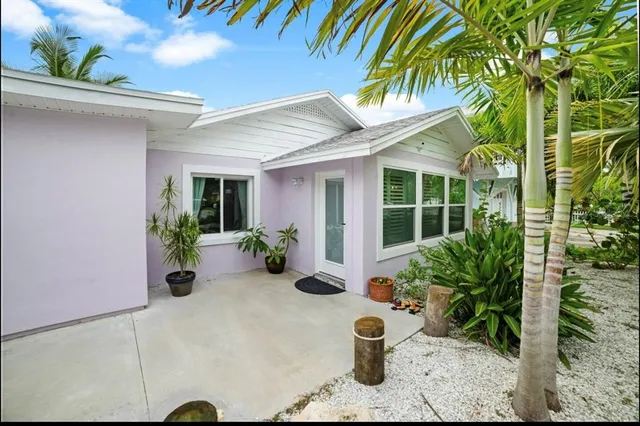 a view of a house with potted plants