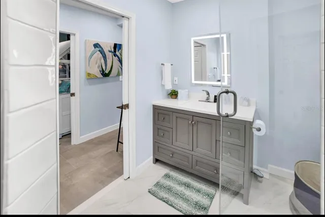 a bathroom with a sink and a mirror