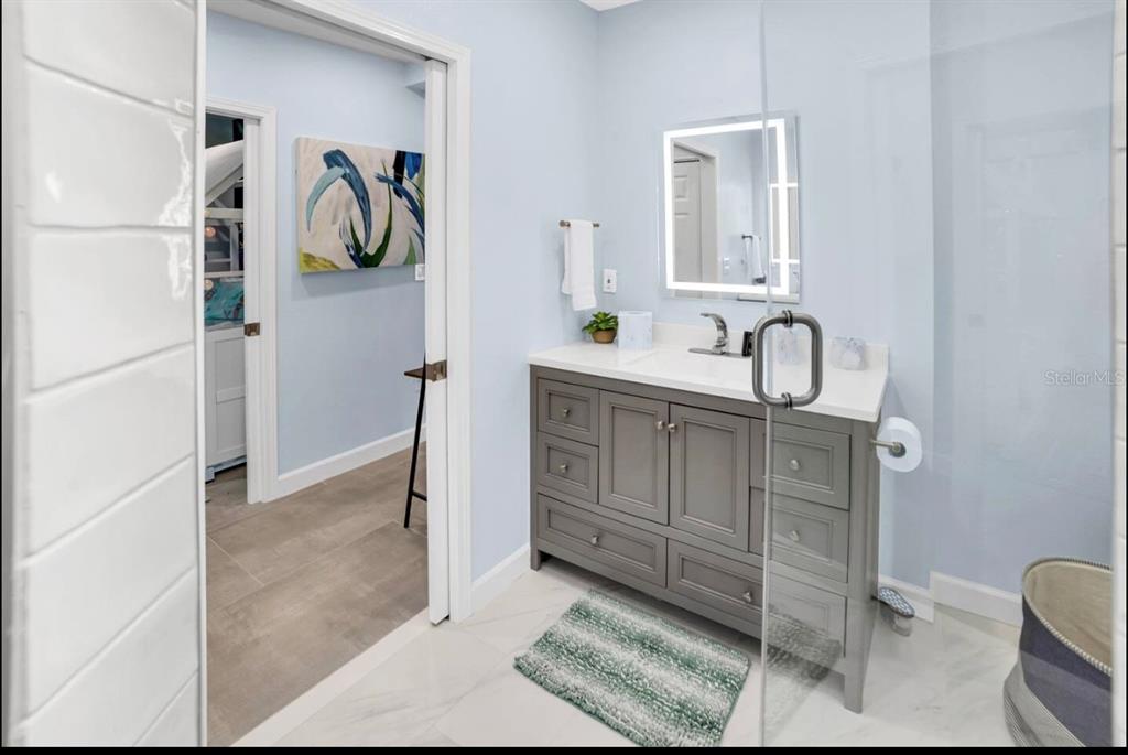 1210 Bay Palm Boulevard Indian Rocks Beach, FL 33785 - Photo 7 of 19 a bathroom with a sink and a mirror