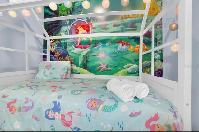 a bedroom with toys and a wooden floor