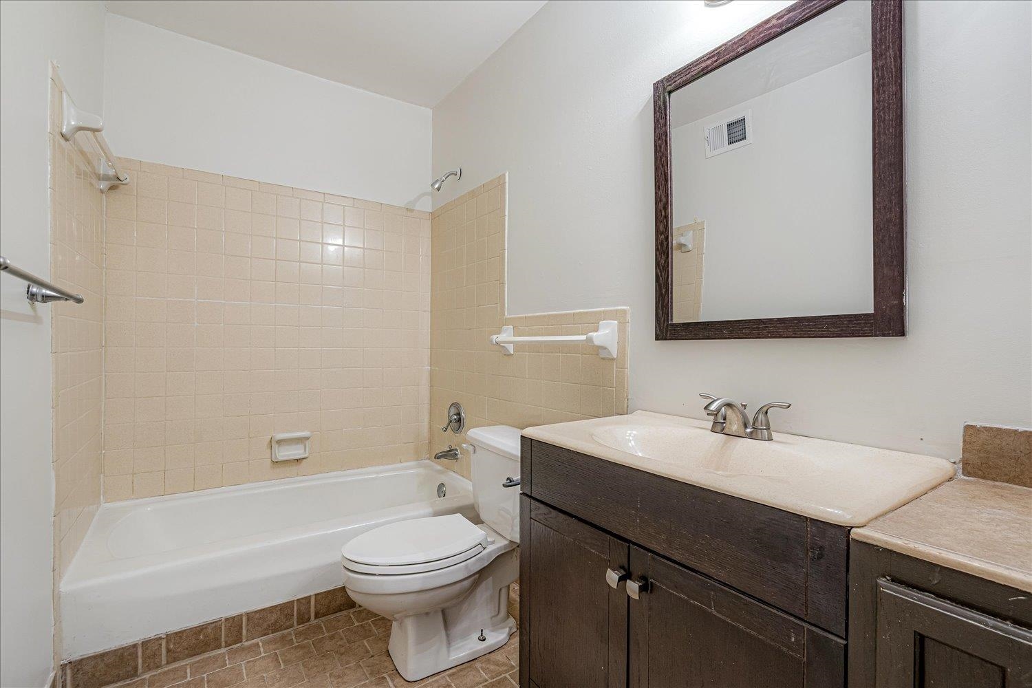 5696 Quince Road, Unit 1 Memphis, TN 38119 - Photo 13 of 26 a bathroom with a sink a toilet and shower