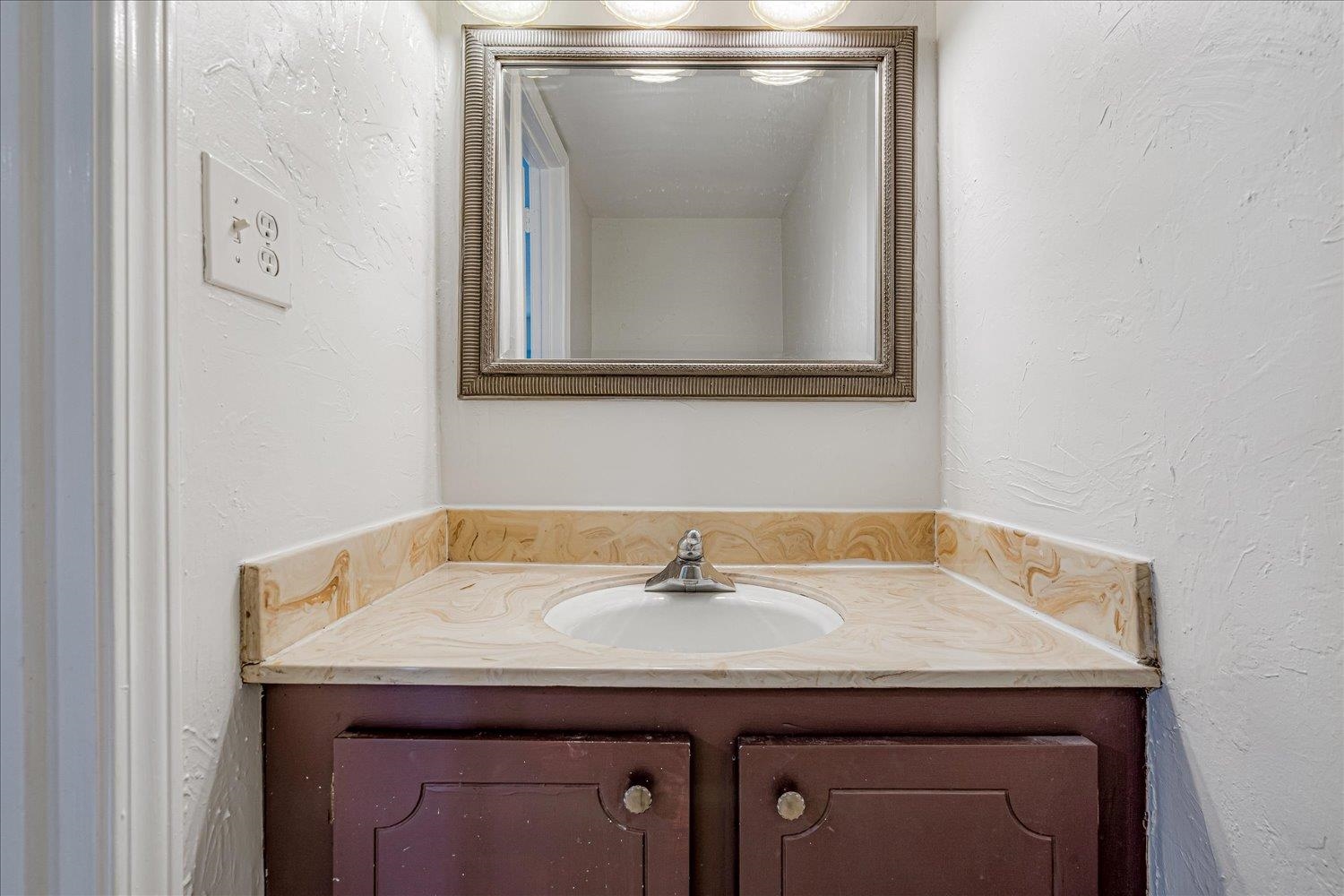 5696 Quince Road, Unit 1 Memphis, TN 38119 - Photo 13 of 26 Bathroom featuring a textured wall and vanity