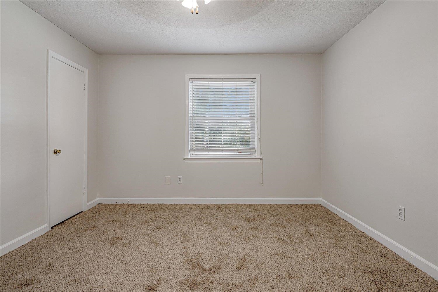 5696 Quince Road, Unit 1 Memphis, TN 38119 - Photo 19 of 26 Spare room featuring light colored carpet and a textured ceiling