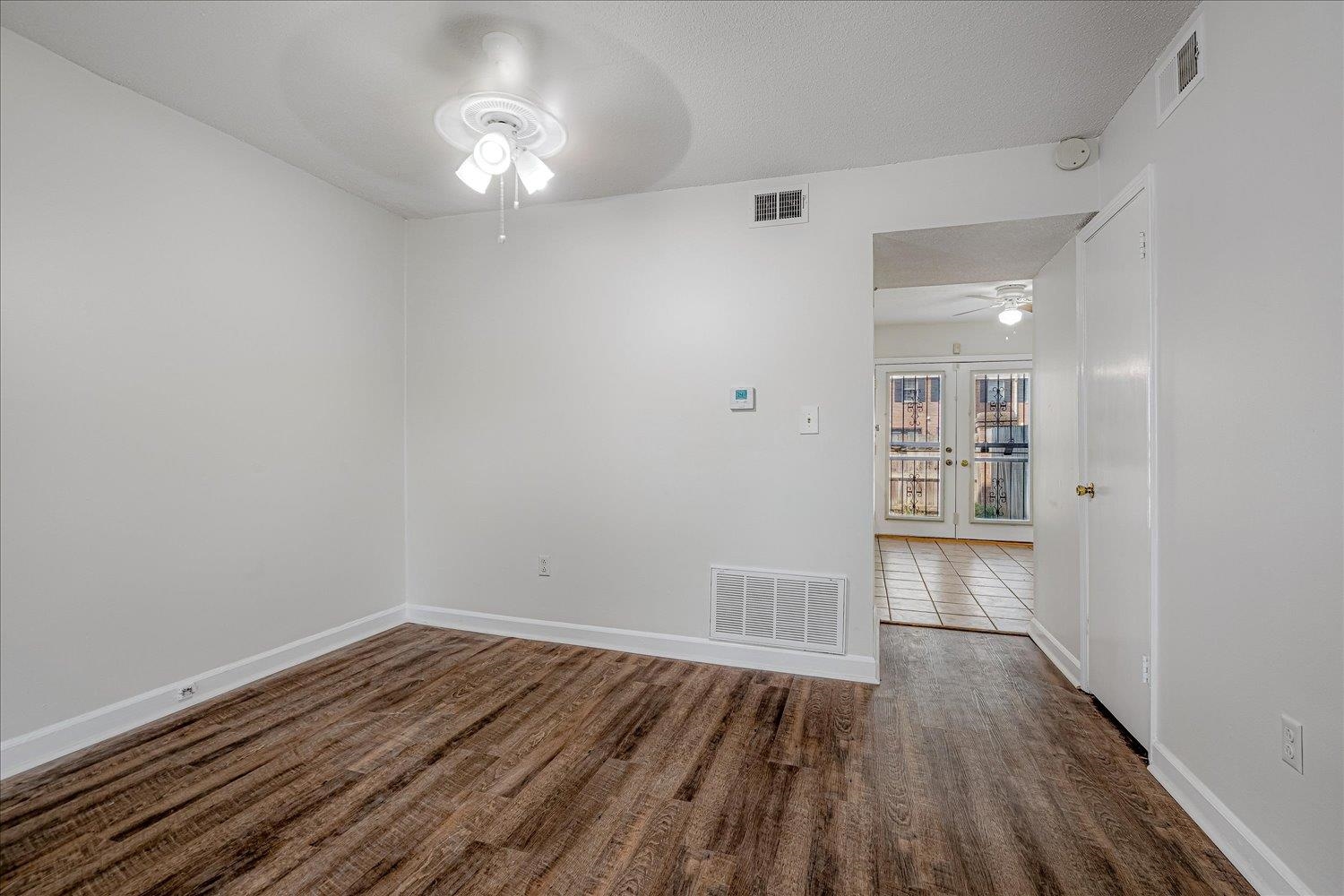 5696 Quince Road, Unit 1 Memphis, TN 38119 - Photo 4 of 26 Empty room with dark wood-style floors and ceiling fan