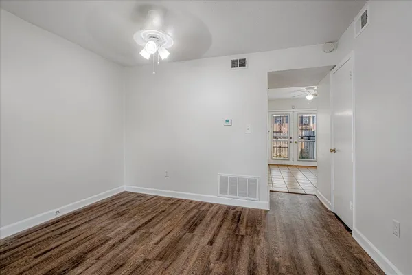 a view of a room with wooden floor and a window