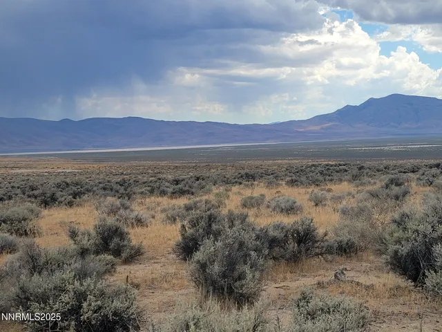 a view of mountain with sunset in background