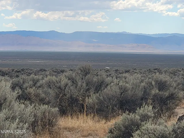a view of mountain with sunset in background