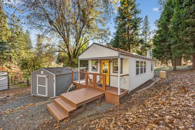 a view of a house with a yard and sitting area