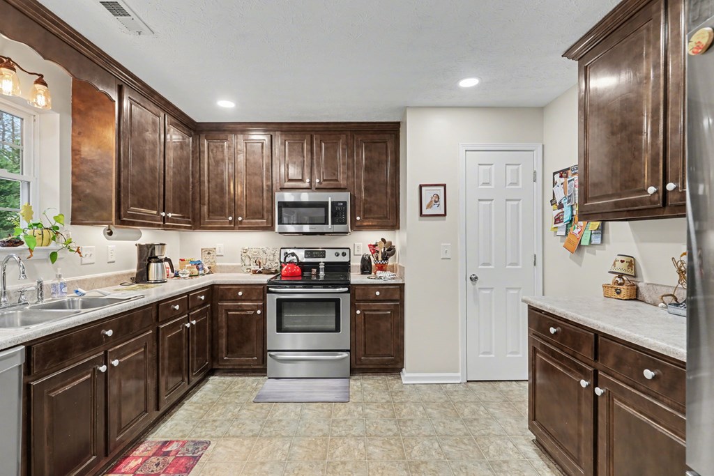 4790 Fires Creek Road Hayesville, NC 28904 - Photo 17 of 61 a kitchen with stainless steel appliances granite countertop a sink stove and refrigerator