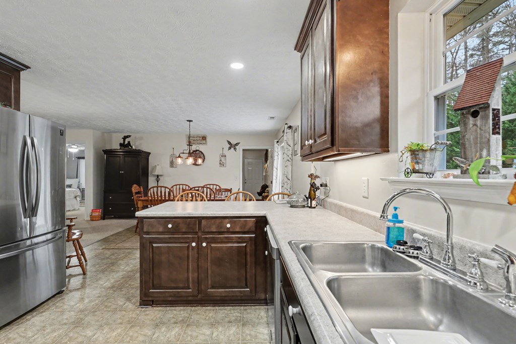 4790 Fires Creek Road Hayesville, NC 28904 - Photo 19 of 61 a kitchen with stainless steel appliances granite countertop a sink and a refrigerator
