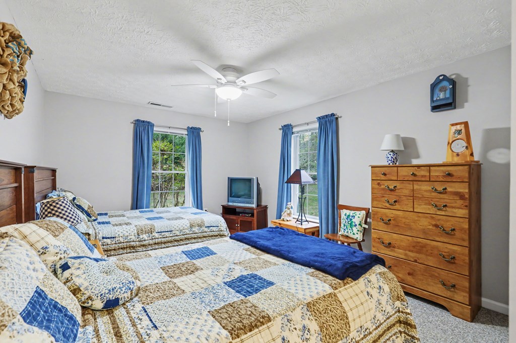 4790 Fires Creek Road Hayesville, NC 28904 - Photo 31 of 61 a bedroom with a bed and a dresser in it
