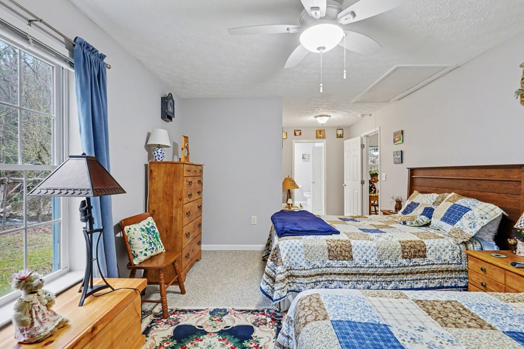 4790 Fires Creek Road Hayesville, NC 28904 - Photo 33 of 61 a bedroom with furniture and a chandelier