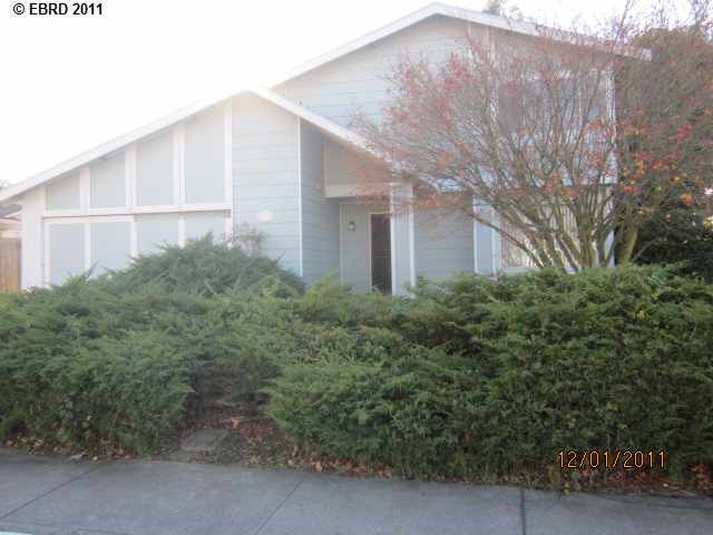 1107 Dennis Court Rodeo, CA 94572 - Photo 1 of 1 a backyard of a house with large trees and plants