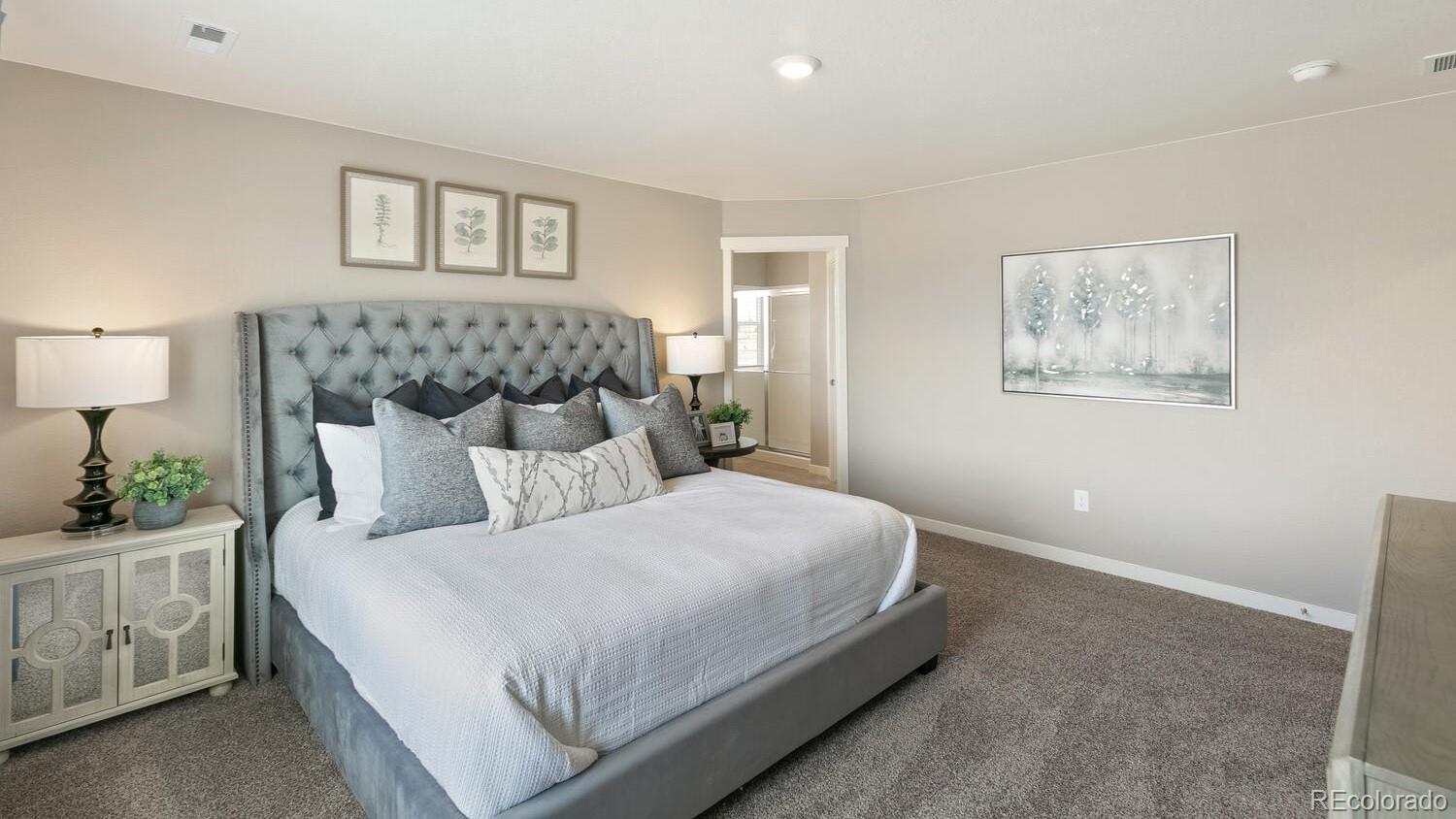 3466 Belleville Ridge Road Elizabeth, CO 80107 - Photo 16 of 24 a bedroom with a large bed and a night stand