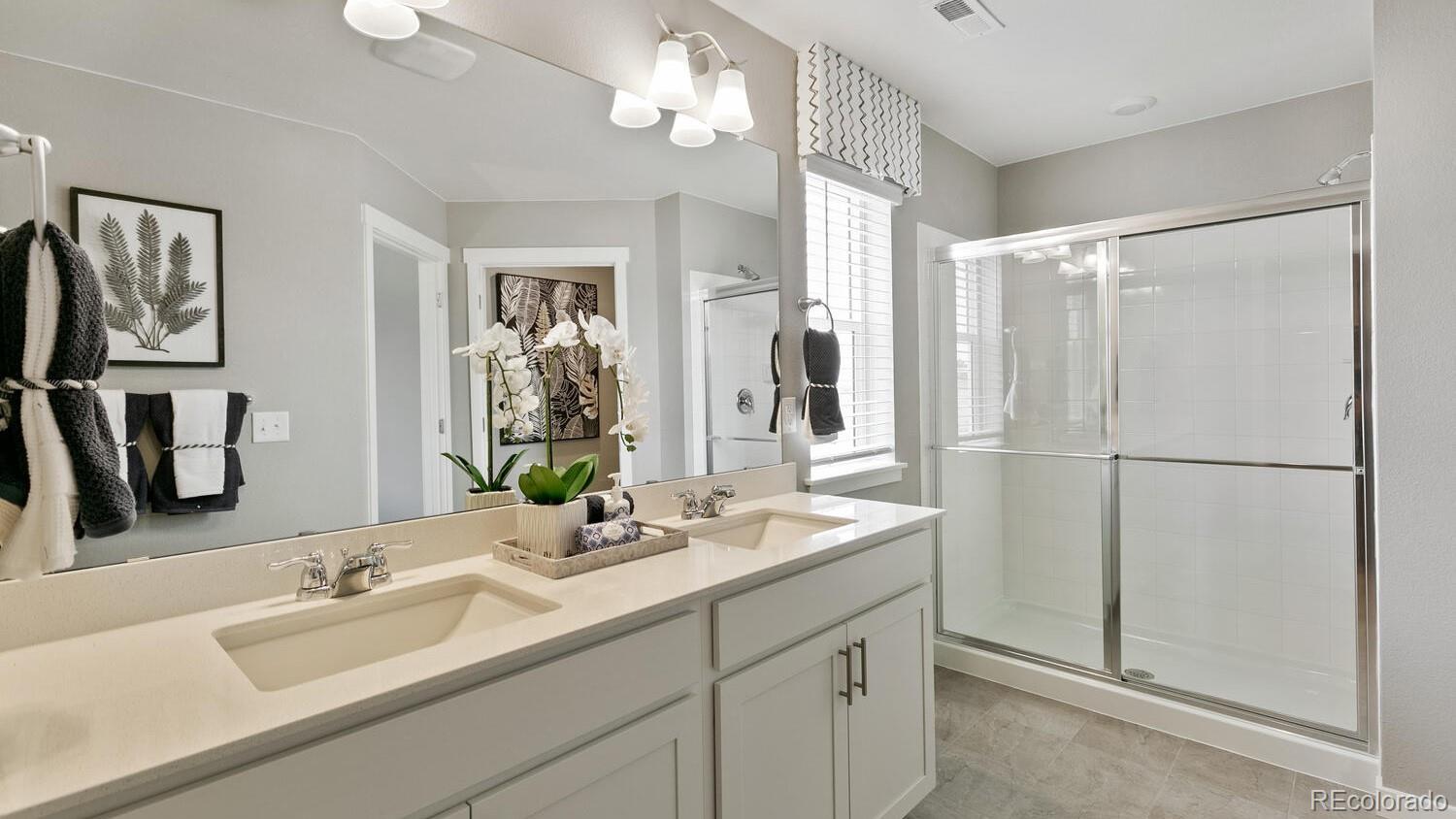 3466 Belleville Ridge Road Elizabeth, CO 80107 - Photo 17 of 24 a bathroom with a double vanity sink mirror and shower