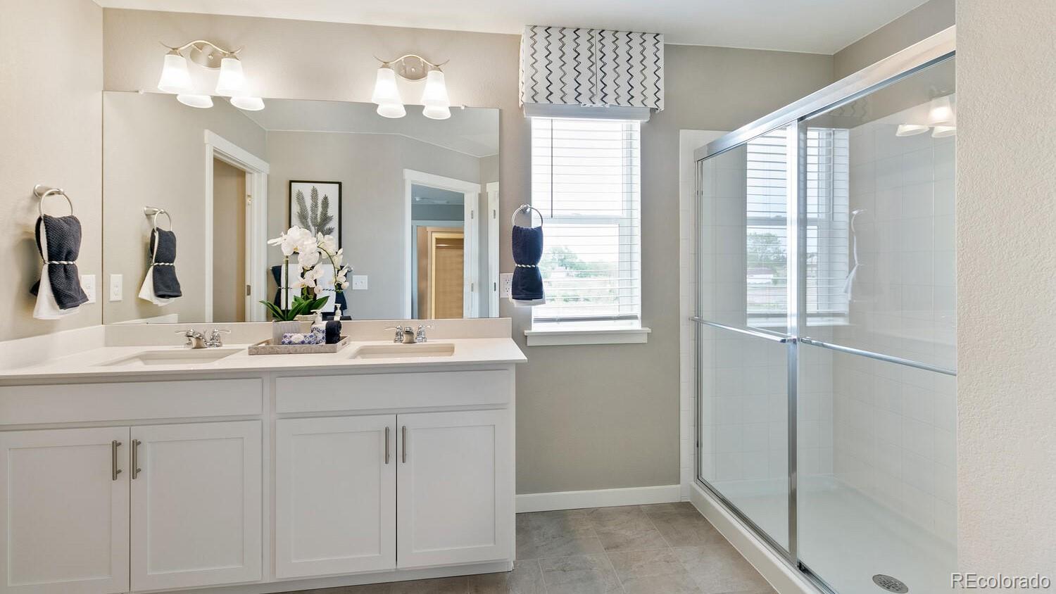 3466 Belleville Ridge Road Elizabeth, CO 80107 - Photo 18 of 24 a bathroom with a double vanity sink and a mirror