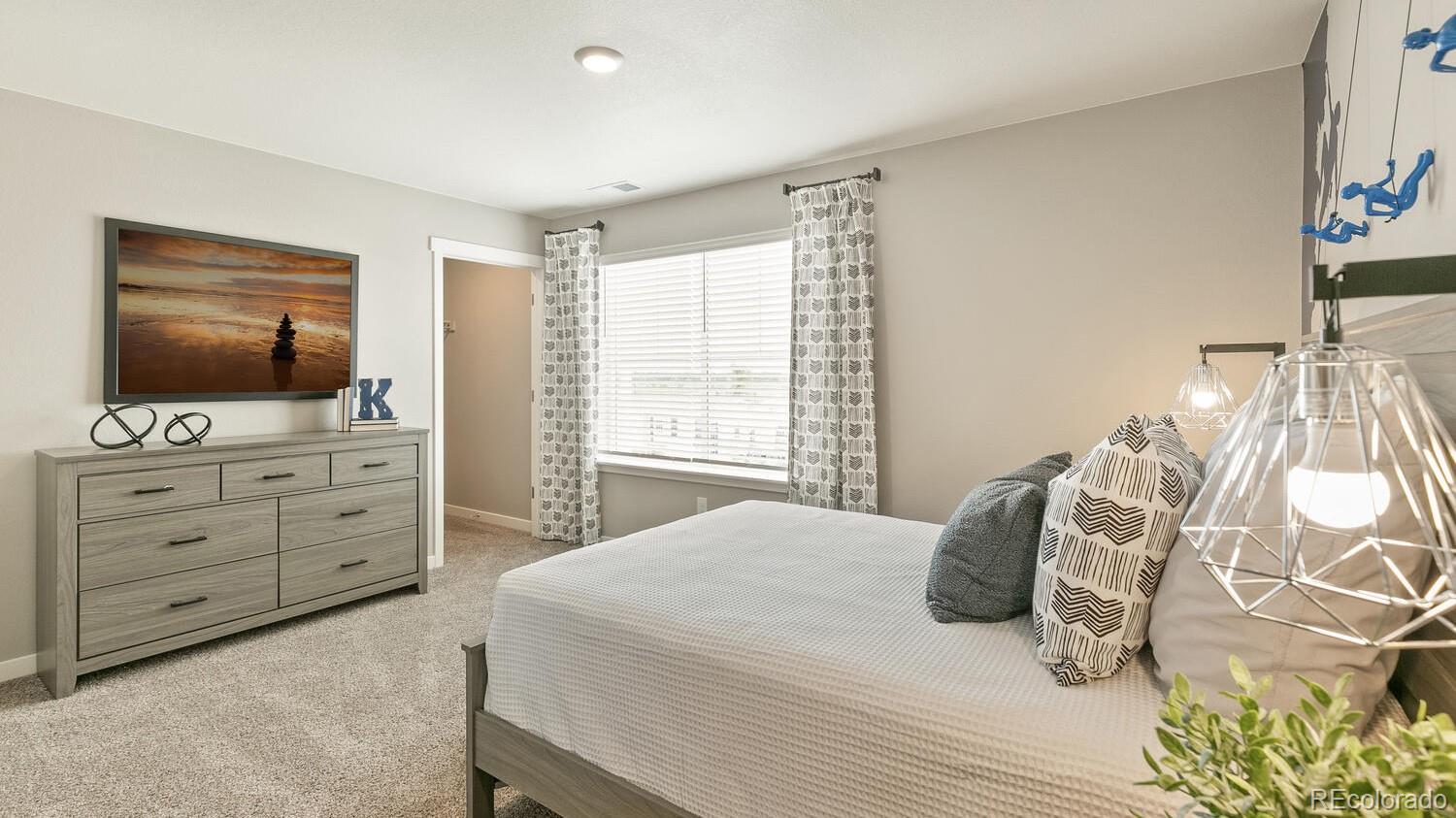 3466 Belleville Ridge Road Elizabeth, CO 80107 - Photo 20 of 24 a bedroom with a bed and a flat screen tv