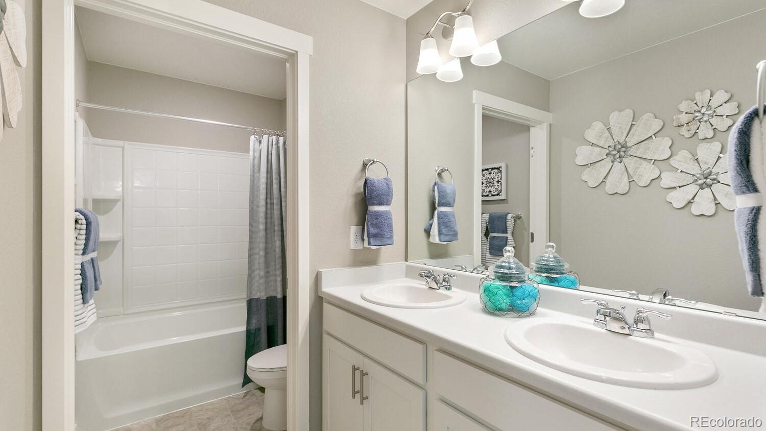 3466 Belleville Ridge Road Elizabeth, CO 80107 - Photo 21 of 24 a bathroom with a granite countertop sink a toilet and a mirror