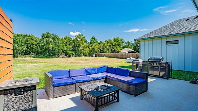 a view of a yard with furniture and a fire pit