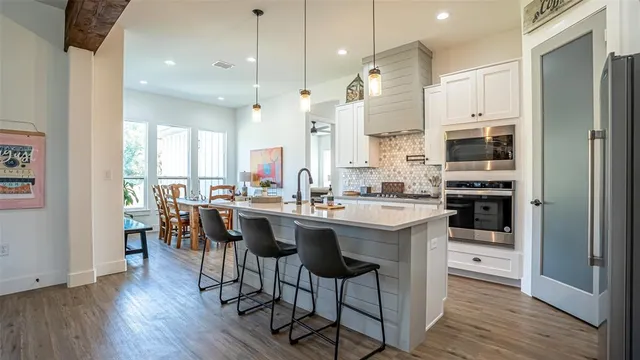 a large kitchen with a table and chairs