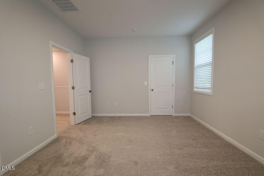 2913 Richardson Road, Unit 475 Apex, NC 27502 - Photo 17 of 24 an empty room with windows and closet