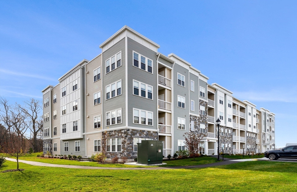 6 Stratton Drive, Unit 303 Woburn, MA 01801 - Photo 31 of 33 a front view of a building with a yard