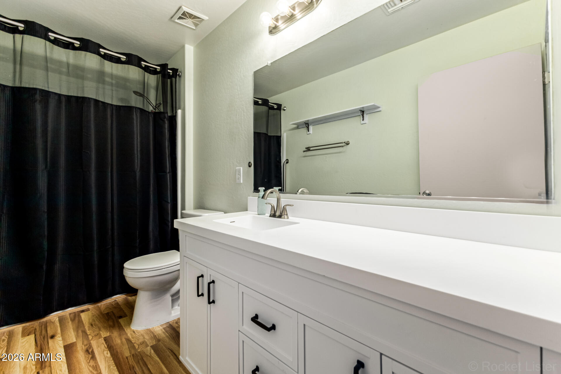 40264 West Lococo Street Maricopa, AZ 85138 - Photo 11 of 29 a bathroom with a sink and a mirror