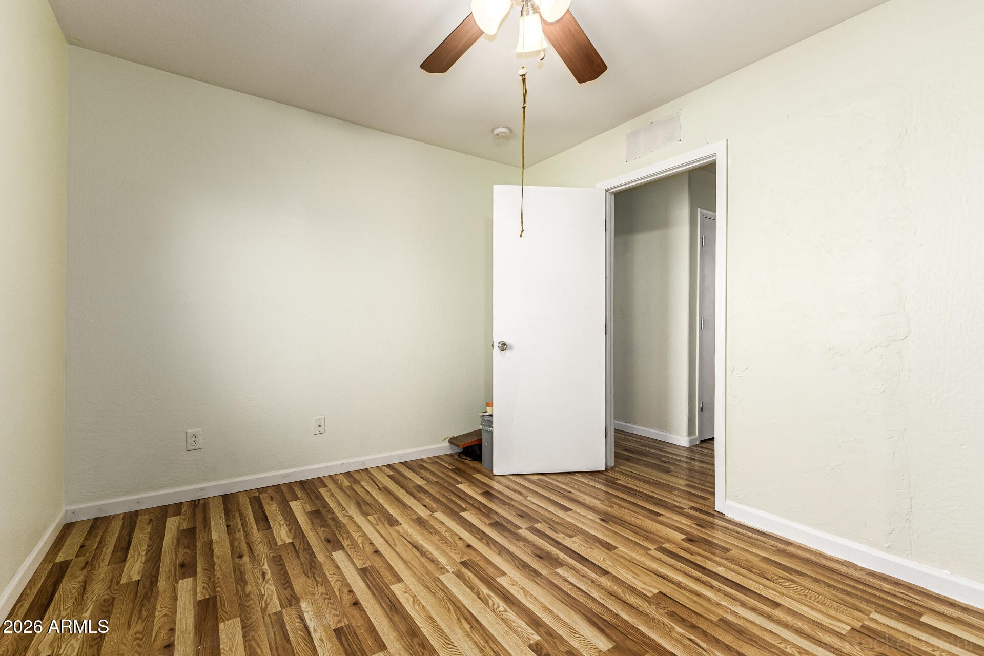 40264 West Lococo Street Maricopa, AZ 85138 - Photo 14 of 29 en empty room with wooden floor and ceiling fan