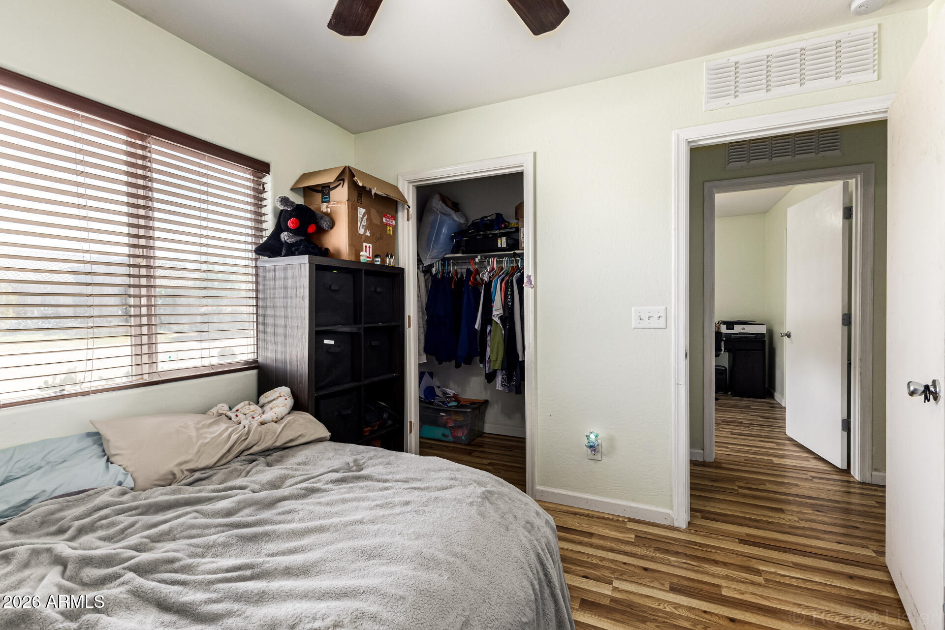 40264 West Lococo Street Maricopa, AZ 85138 - Photo 16 of 29 a bedroom with a bed and a window